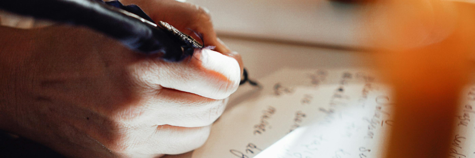 A single lit candle in darkness, representing hope and guidance